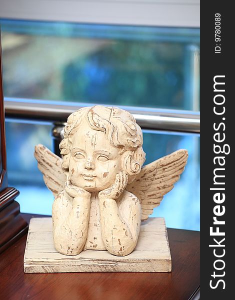 Sculpture of the wooden angel on a table