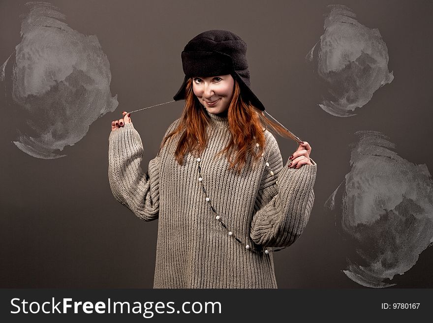 Young pretty woman in hat smiling separated over grey background