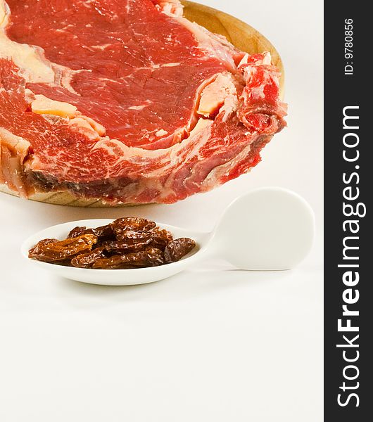 Meat and chili peppers on white background. Meat and chili peppers on white background