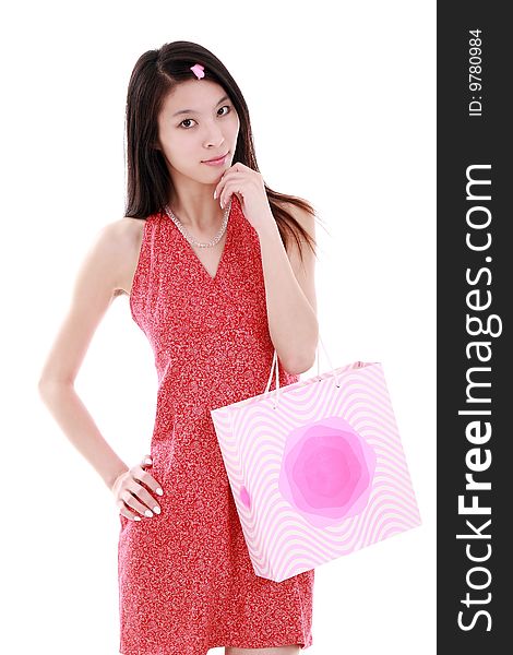 A beautiful Asian girl holds a shopping bag on white background. A beautiful Asian girl holds a shopping bag on white background.