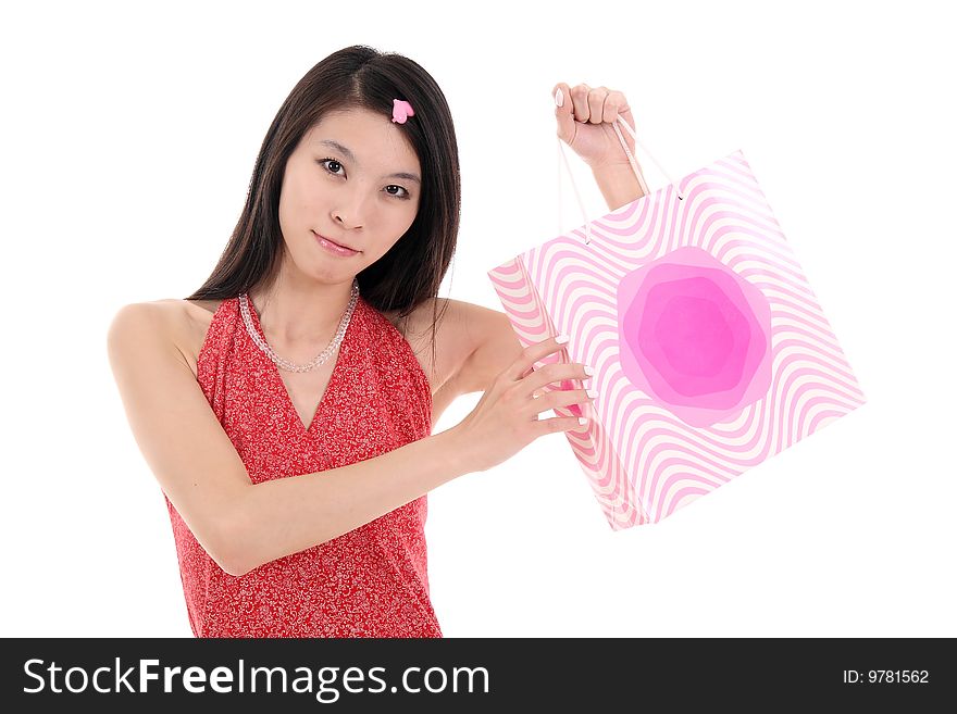 A beautiful Asian girl holds a shopping bag on white background. A beautiful Asian girl holds a shopping bag on white background.