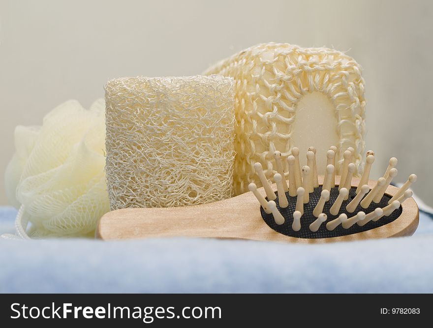 Bath sponges and massage brush for bath on a blue towel. Bath sponges and massage brush for bath on a blue towel