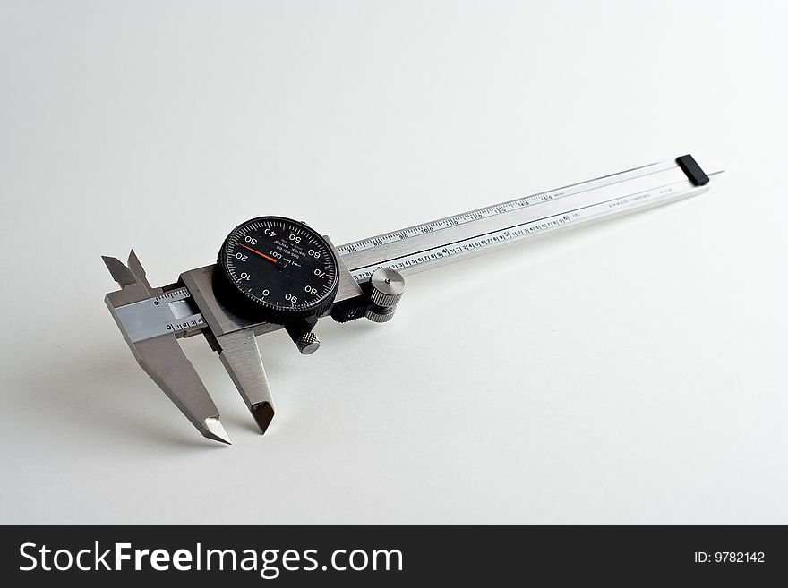 Six inch dial caliper isolated on a white background.