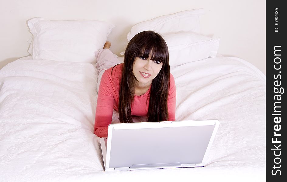 Woman using a laptop in the bedroom. Woman using a laptop in the bedroom