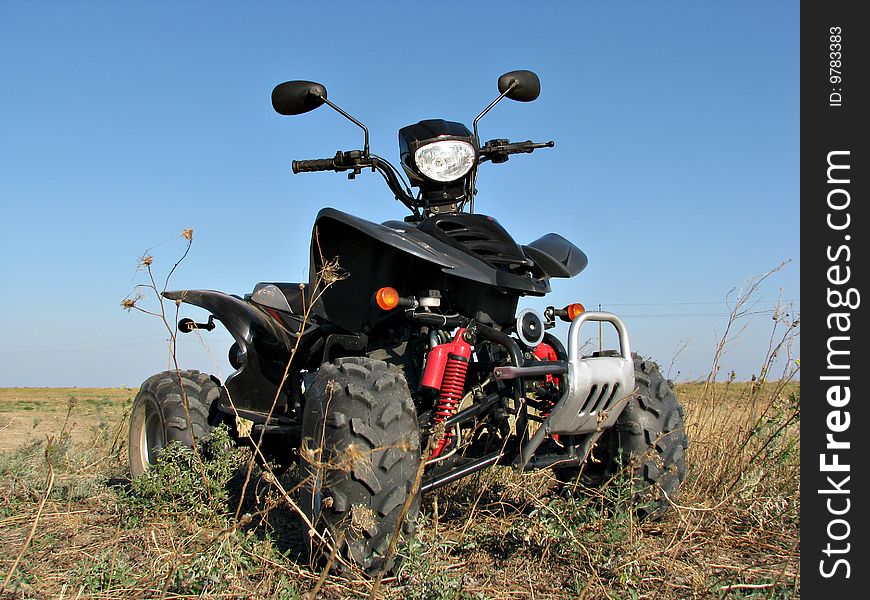 Quad standing in the dry steppe grass. Quad standing in the dry steppe grass