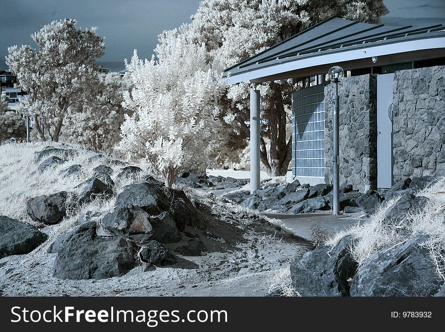 Surreal infrared photo of beach changing rooms