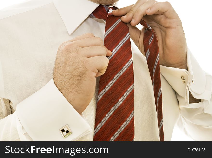 Handsome young businessman adjusting tie