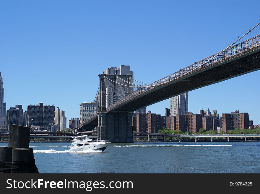 Boat passing under the Brooklyn Bridge. Boat passing under the Brooklyn Bridge