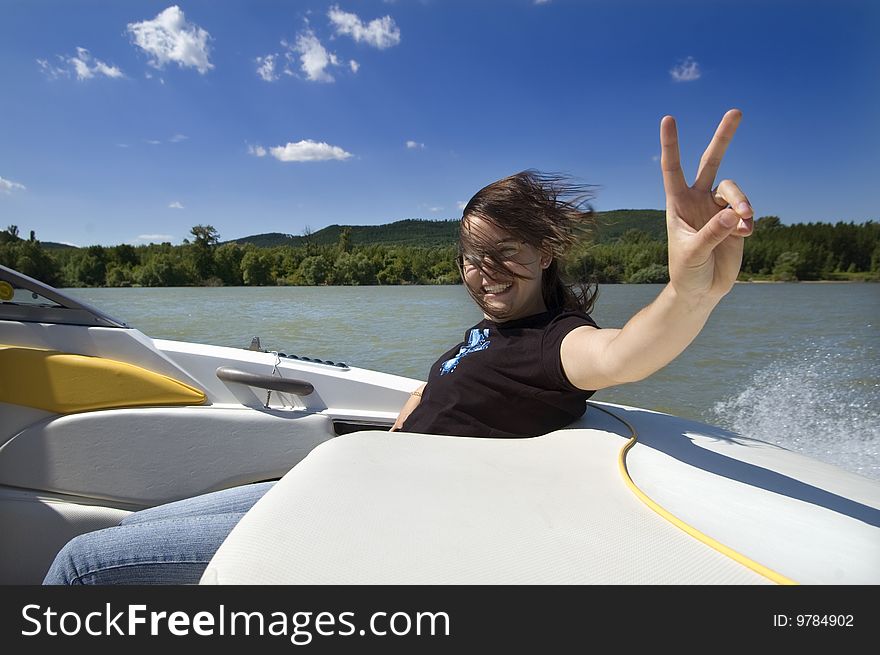 Happy smiling young girl traveling on a motorboat. Happy smiling young girl traveling on a motorboat