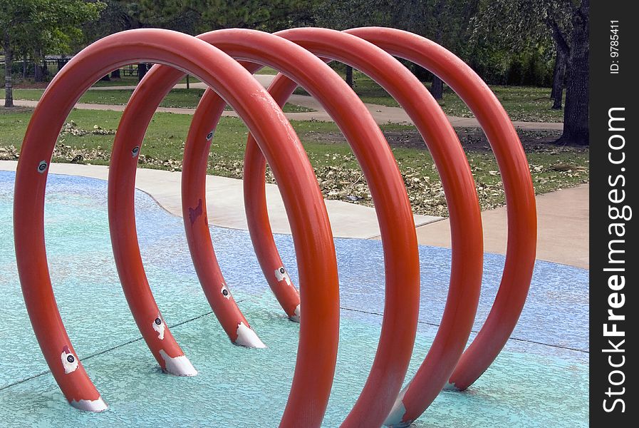 A red circled jungle gym at a playground for kids