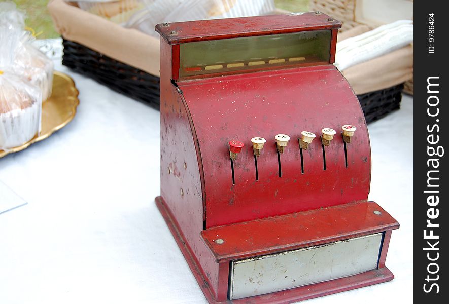 A vintage cash register at an outdoor market