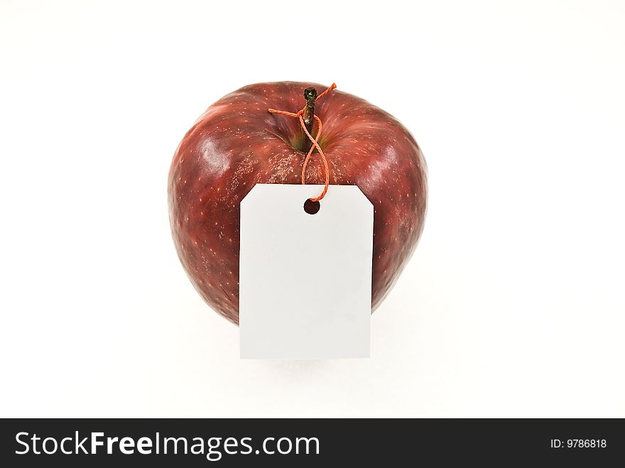 Red apple with tag isolated on white