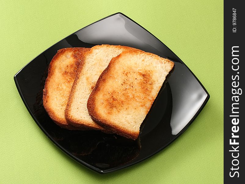 Three hot toast on black plate. Three hot toast on black plate