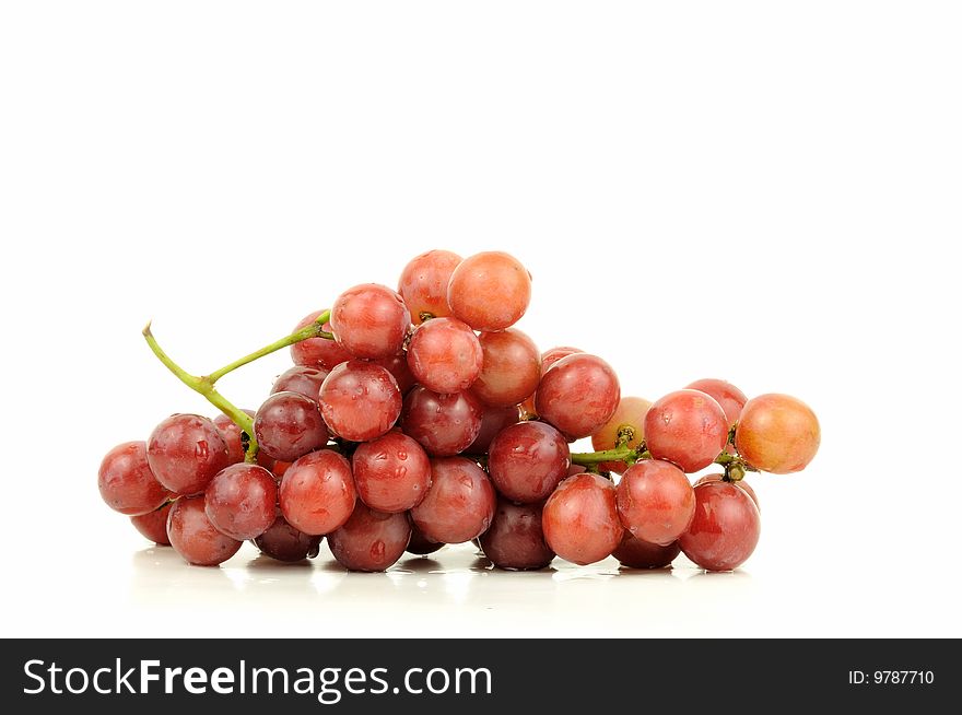 Red seedless grapes bunch isolated over white. Red seedless grapes bunch isolated over white