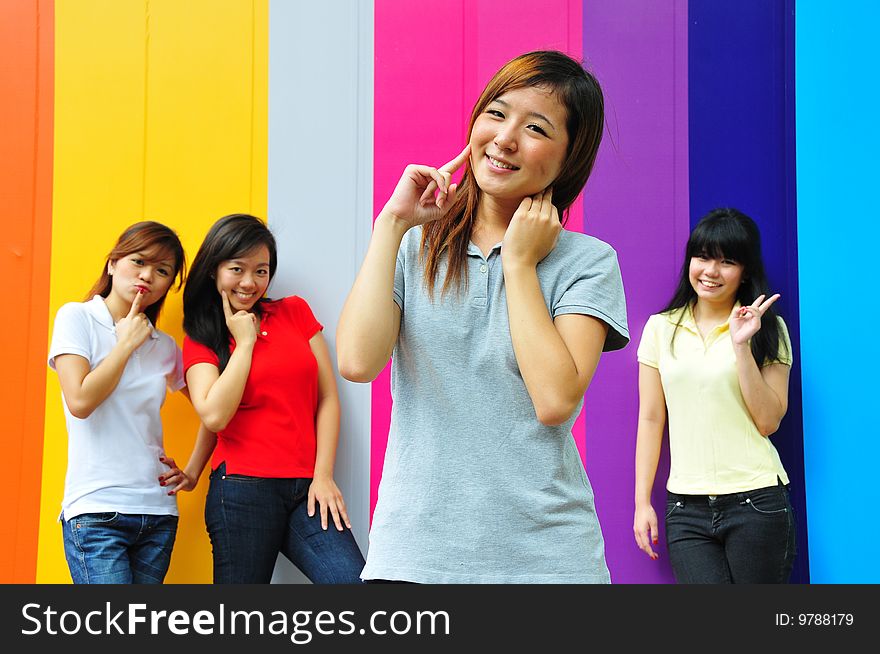 Beautiful Young Women Having Fun With Colourful Background. Beautiful Young Women Having Fun With Colourful Background.