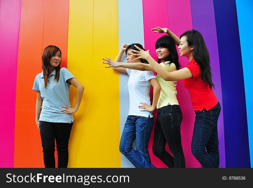 Beautiful Young Women Having Fun with Colouful Backgound.