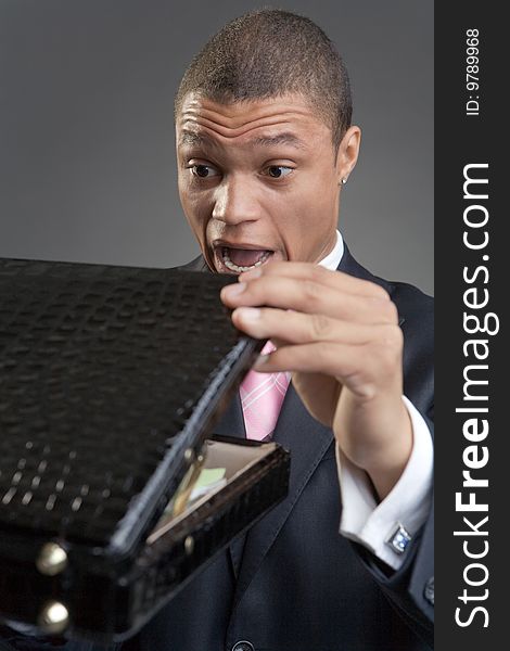 The businessman with a briefcase on a dark background