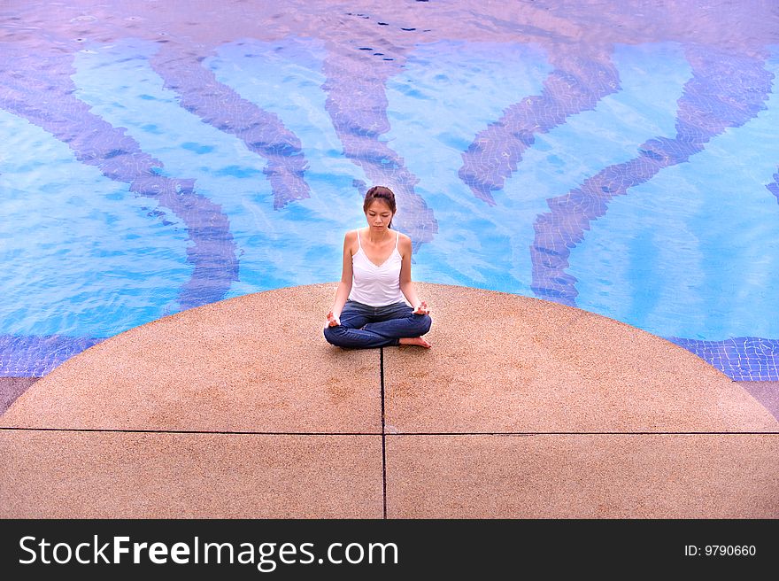 An image of an asian girl meditating. An image of an asian girl meditating