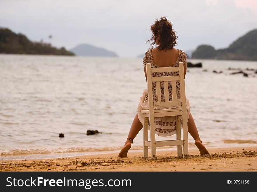 Woman to sit on the chair at sunset. Woman to sit on the chair at sunset.