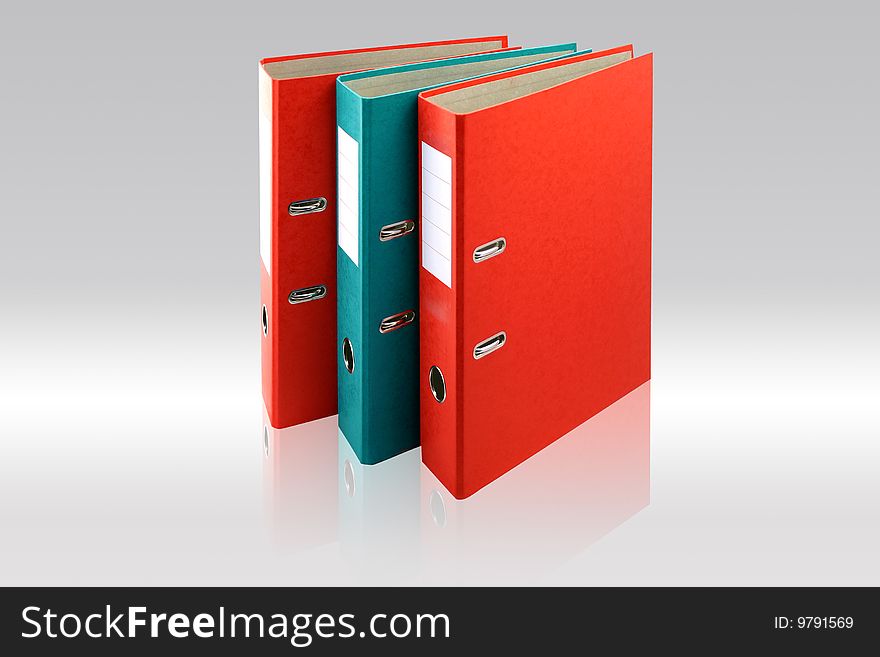Two red business folders and one green on gray background.