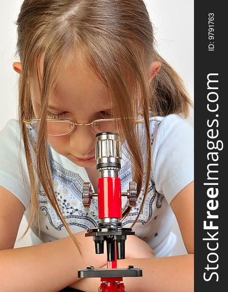 Girl studying something with microscope