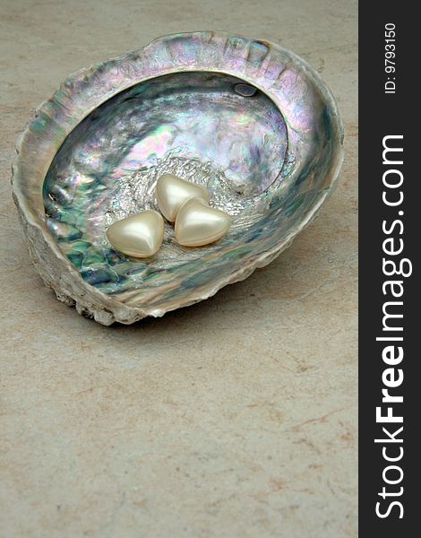 Heart shaped bath pearls on a shell. Heart shaped bath pearls on a shell