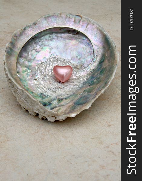Heart shaped bath pearl on a shell. Heart shaped bath pearl on a shell