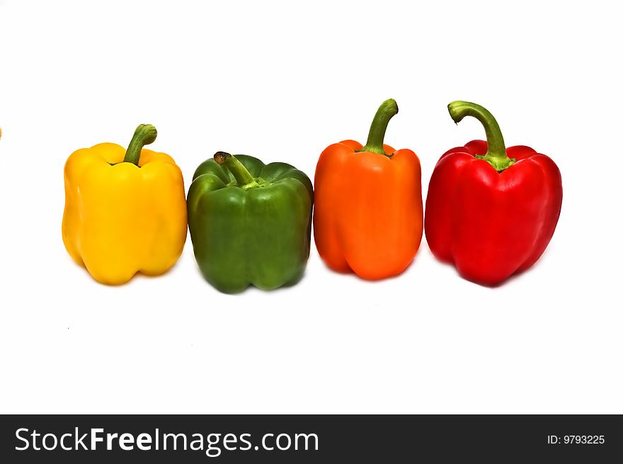 Photo of four colorful peppers