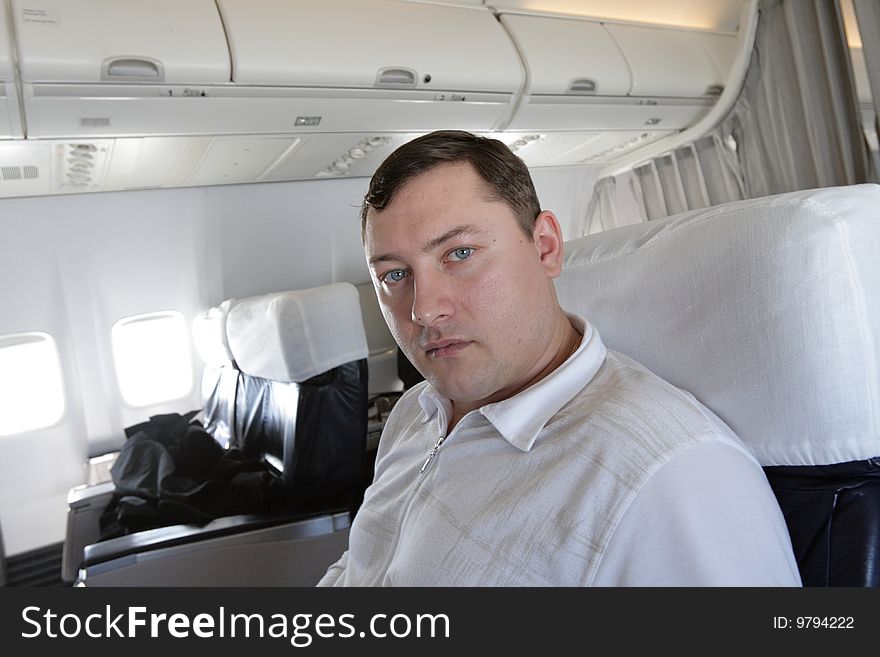 Tourist waits a flight in cabin of air liner. Tourist waits a flight in cabin of air liner