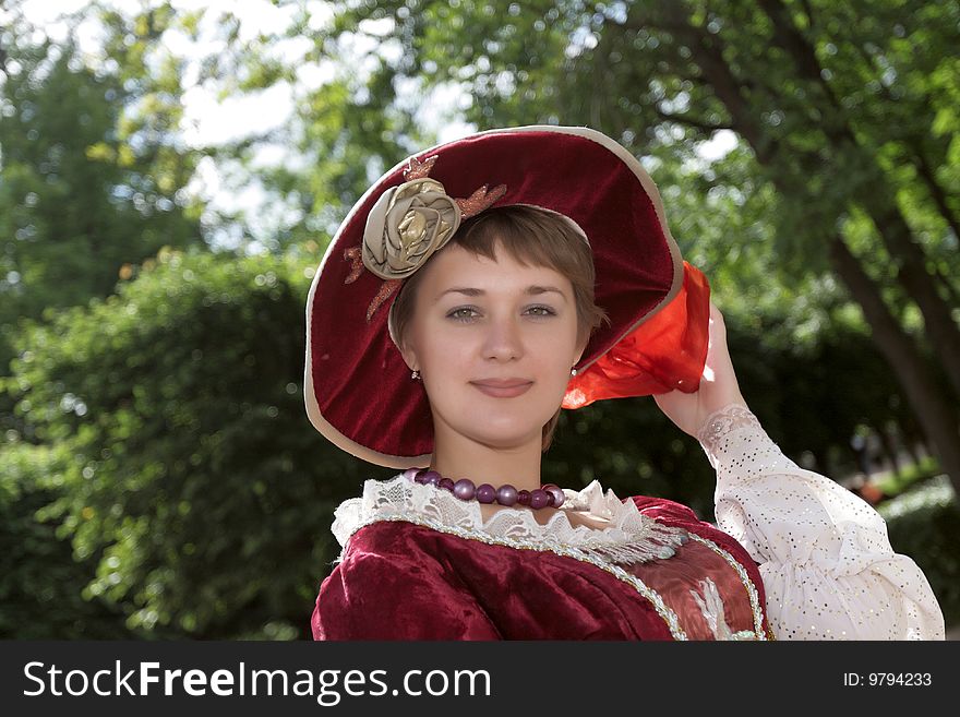 The woman poses in a retro bonnet. The woman poses in a retro bonnet