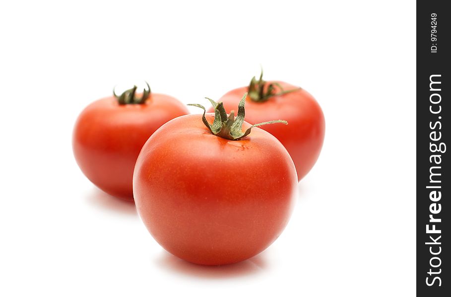 Three red riped tomatos on white background. Three red riped tomatos on white background