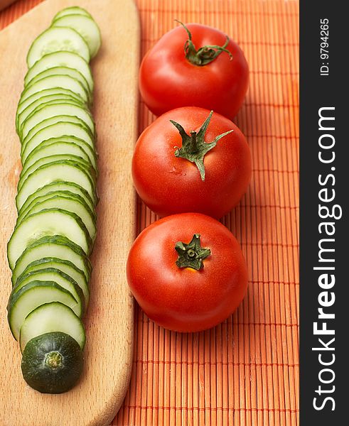 Red-ripe tomatoes and slices of cucumber