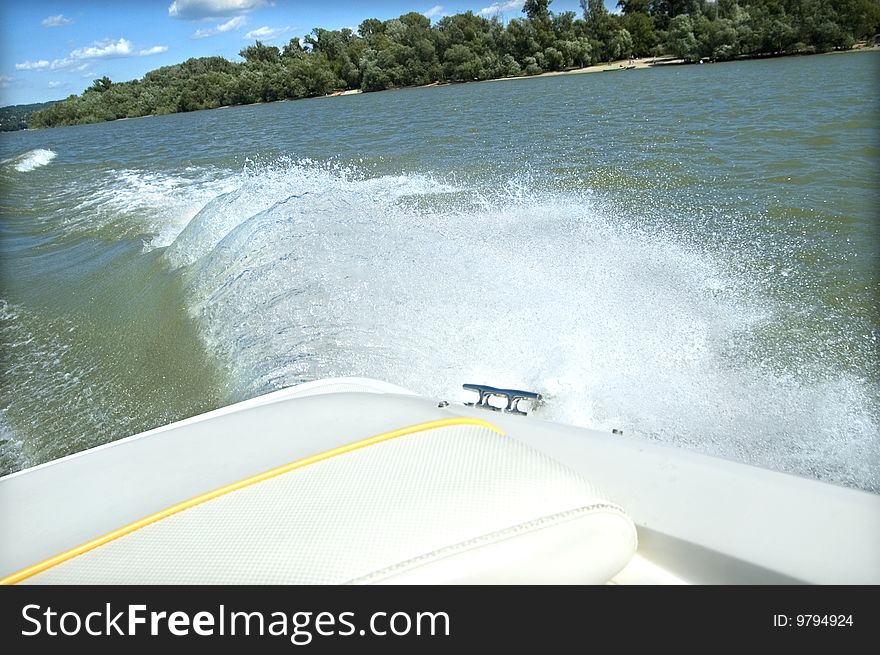 Motorboat splash and wake on the river