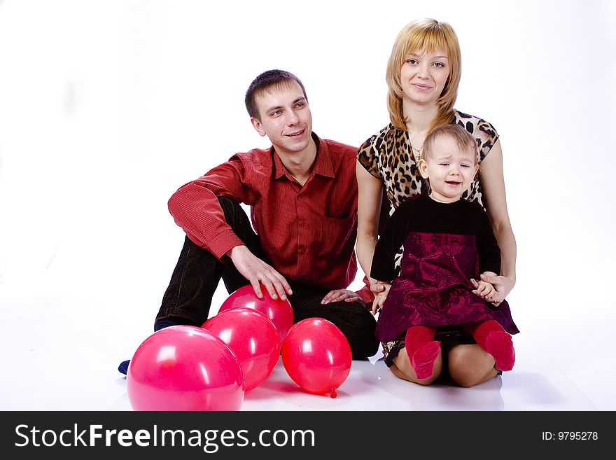 Family of three people. with a small child and balls