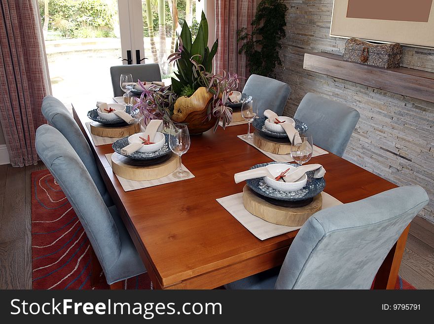 Luxury home dining room table with exquisite tableware and decor.