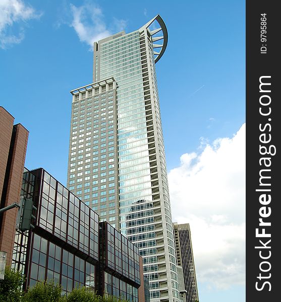 High modern skyscraper on a background of the blue sky. Frankfurt am Main, Germany