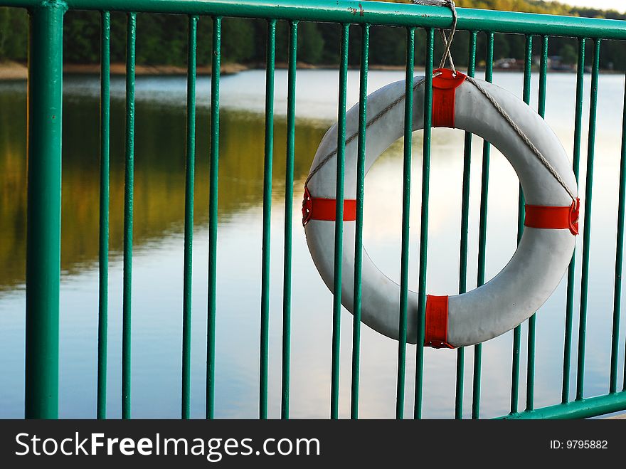 Life buoy on a green metal fence