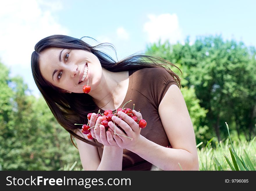 Portrait of the happy girl with cherry
