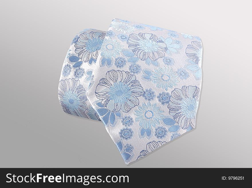 Blue tie on a grey background
