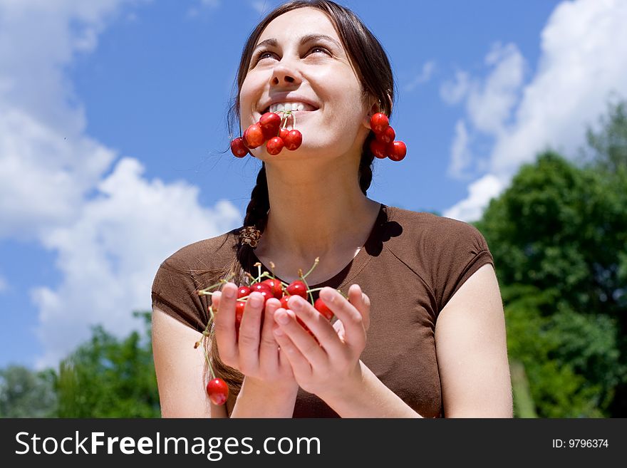 Portrait of the happy girl with cherry