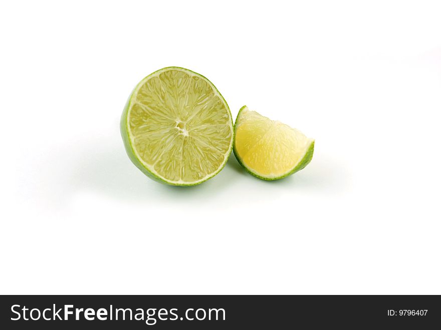 A lime sliced in half and then into individual piece. A lime sliced in half and then into individual piece