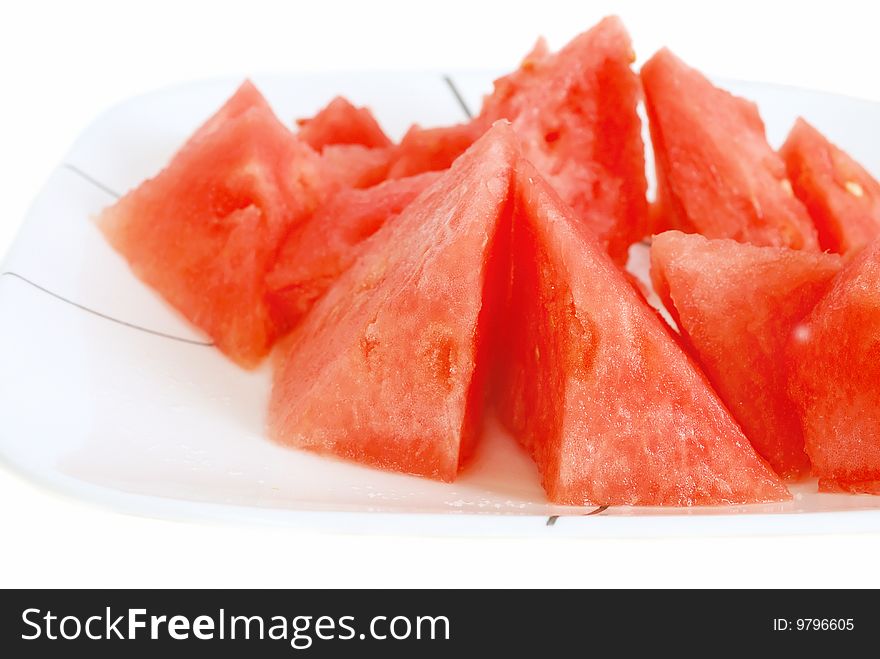 Sliced watermelon on the plate isolated on the white.