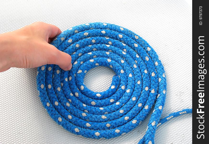 White caucasian hand keeping blue rope