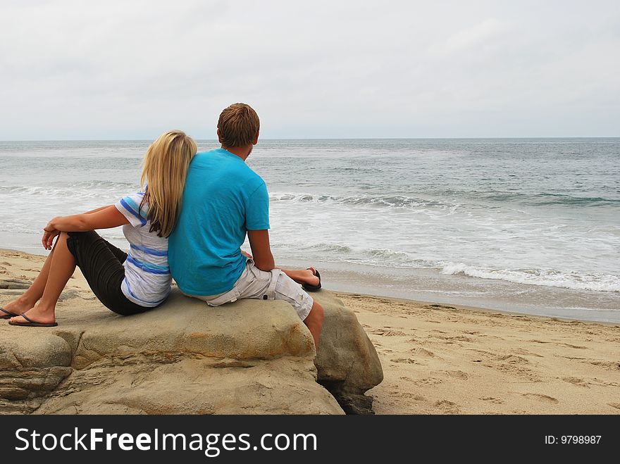A couple gazes over the ocean in Laguna Beach, CA. A couple gazes over the ocean in Laguna Beach, CA.