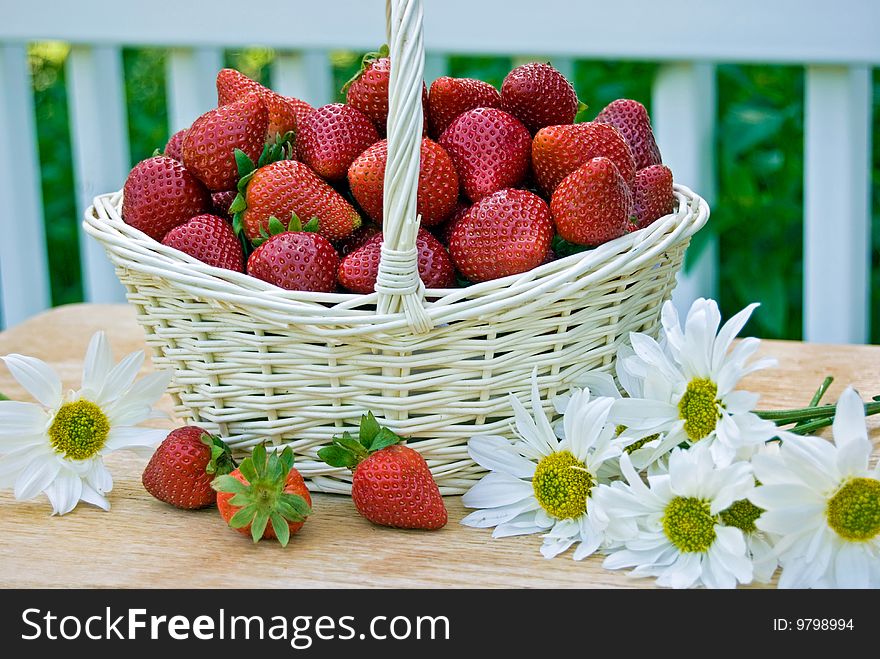 Basket of strawberries with daisies. Basket of strawberries with daisies.