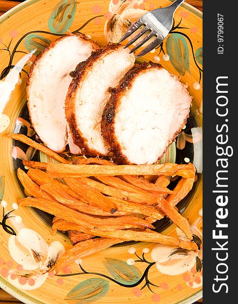 Chipotle glazed turkey roast with sweet potato fries. Chipotle glazed turkey roast with sweet potato fries