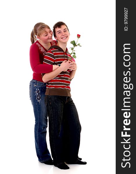 Two casual dressed teenagers , teenage man holding rose flower and woman in love. studio shot. Two casual dressed teenagers , teenage man holding rose flower and woman in love. studio shot.