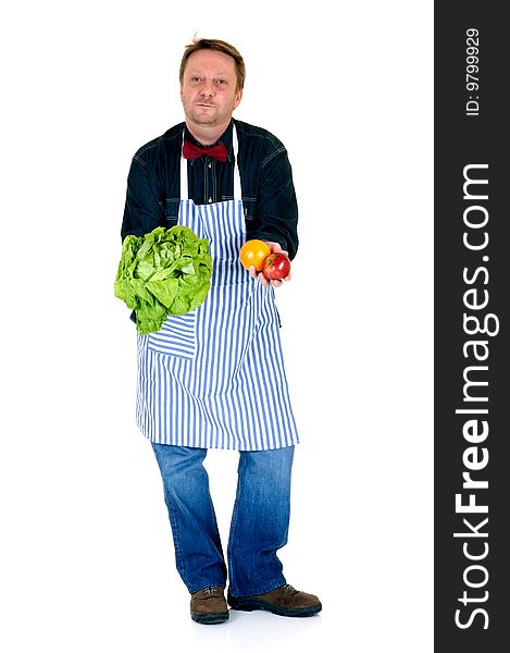 Happy cook showing some fresh vegetables and fruits on white background, reflective surface