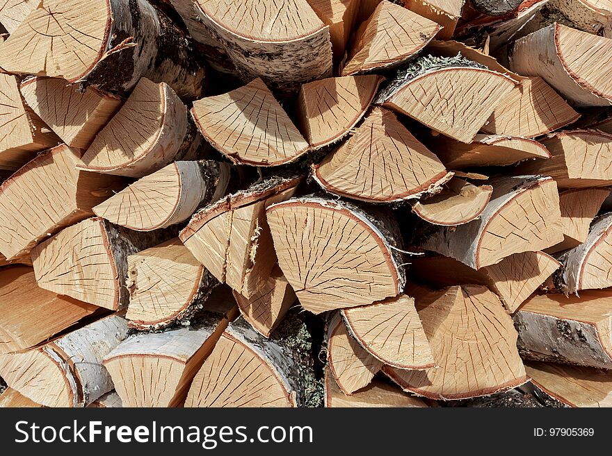 Birch split firewood stacked in the woodpile