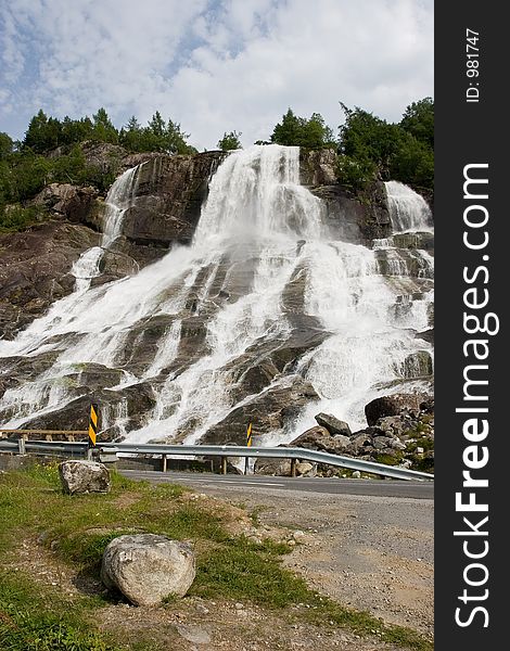 A waterfall in Norway along the main road with ice cold glacier water